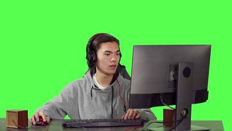 Young-player-sitting-at-computer-desk